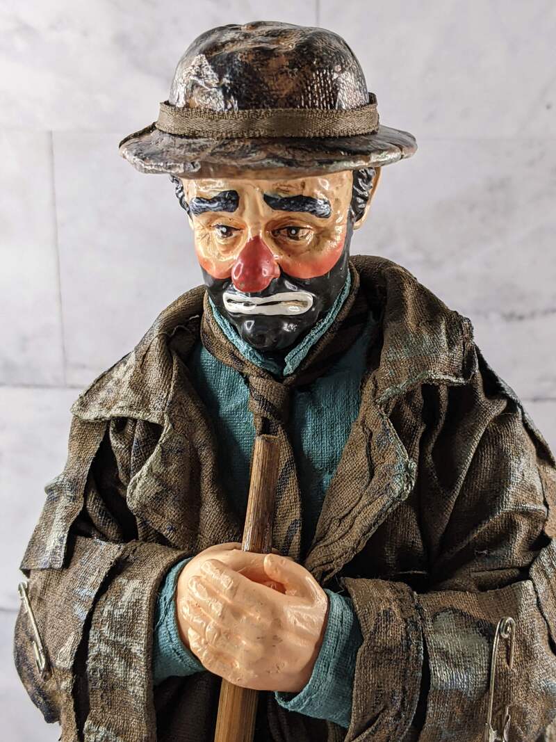 An Emmet Kelly Clown limited edition Spotlight figurine of a sad clown holding a broom.