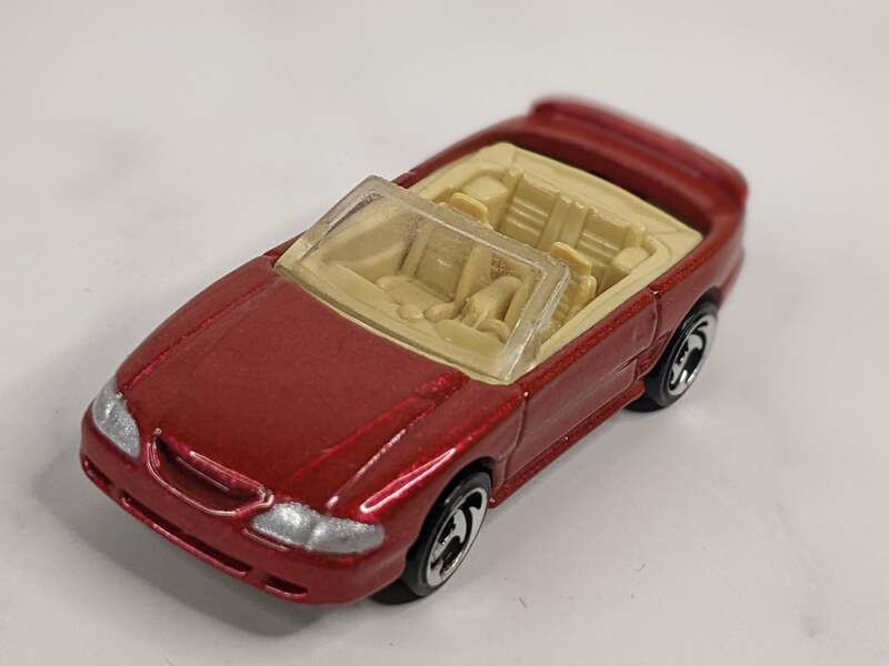 A vintage red convertible Hot Wheels car toy 1996 Mustang GT.