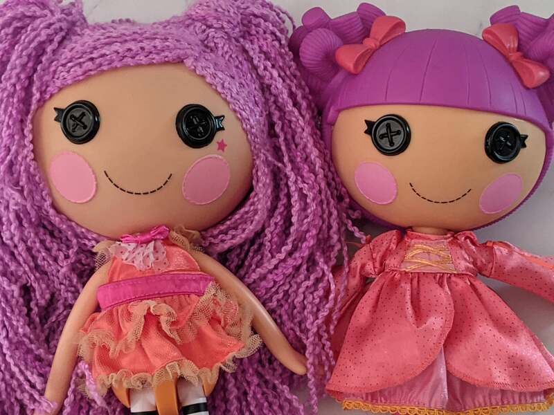 Two toy dolls with purple hair by Lalaloopsy: Loopy Hair Peanut Big Top doll and Lady Stillwaiting doll.